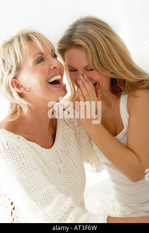 Two women gossiping together Stock Photo