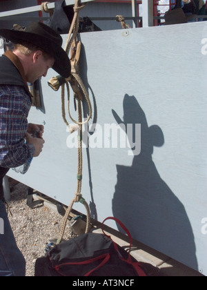 Shadows of Cowboy in full dress and gear before the Tucson Rodeo competition Stock Photo