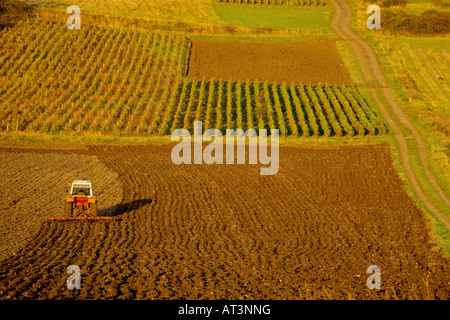 Farming in Europe - Farmer in tractor ploughing in his field in the Auvergne. France Stock Photo