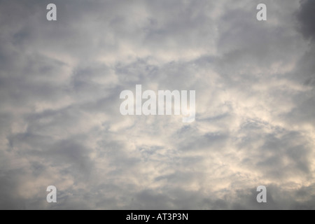 Altocumulus perlucidus  Mass of folding white clouds with portions of gray at the edges. Stock Photo