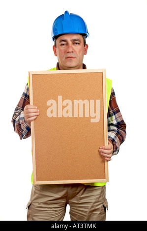 Construction worker with green safety vest holding the empty corkboard on white background Stock Photo