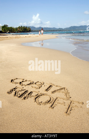 Costa Rica Caribbean Coast words Costa Ripoff written in sand on beach Stock Photo