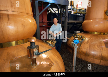 Tobermory Whisky Distillery, Isle of Mull. Scotland. Still man Ruairaidh Currie. Traditional copper pot stills in the Still Room Stock Photo