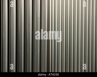 cold uniform silver tubes arranged vertically Stock Photo