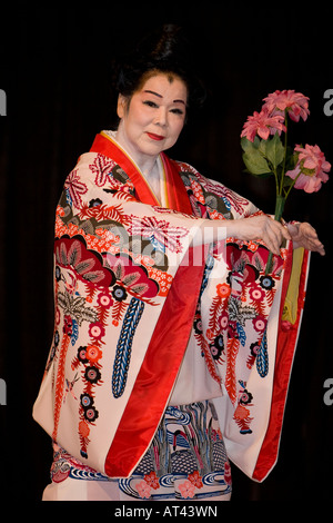 Traditional Okinawan female dancer with flowers Stock Photo