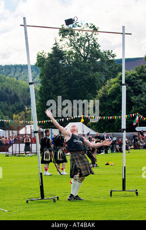 Man throwing the weight over the bar, a traditional style of game ...