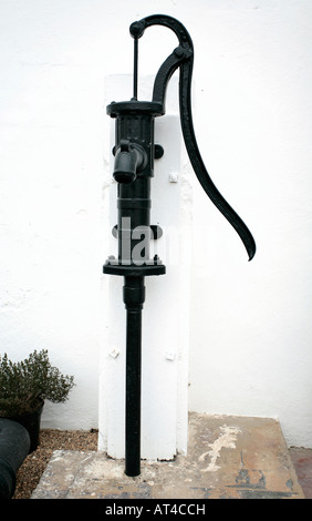 Black cast iron water pump inside greenhouse Stock Photo