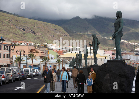 tourists walk past statues of the guanche chiefs in Candelaria the original inhabitants of tenerife canary islands spain Stock Photo