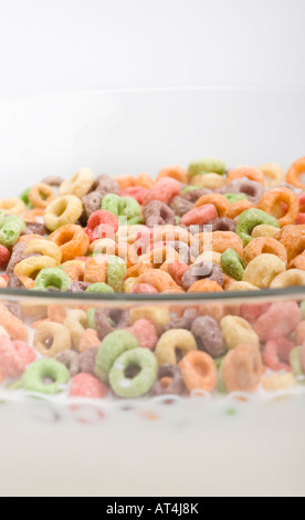 Cereal colorful rings Cheerios in a glass bowl with milk from above pictures images photos very high resolution vertical format in USA US hi-res Stock Photo