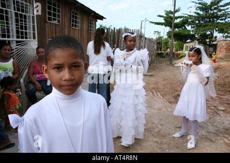 Children celebrate their first commune in the local slum church Stock Photo