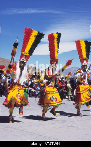 Masked tobas dancers wearing costumes in national colours, Chutillos festival, Potosi, Bolivia Stock Photo
