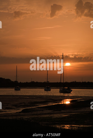 Boats anchored in Chichester harbour at sunset Bosham West Sussex UK Stock Photo
