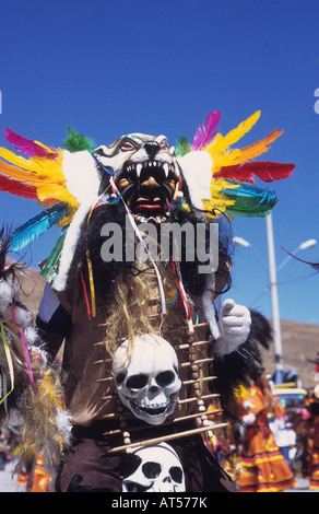 Portrait of a tobas shaman / wizard dancer wearing a white plastic skull and feather headdress, Ch'utillos festival, Potosi, Bolivia Stock Photo