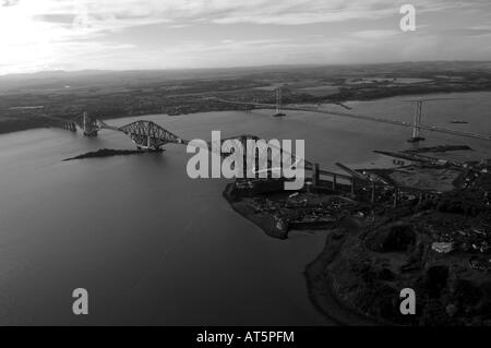 Aerial shot from the north east of the Forth rail and road bridges crossing the Firth of Forth in Scotland