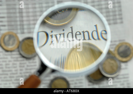 Euro coins under magnifying glass, close-up Stock Photo