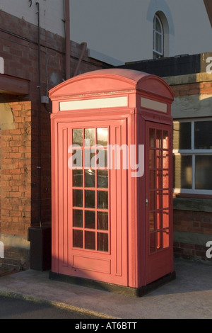 A red telephone box in a station Stock Photo