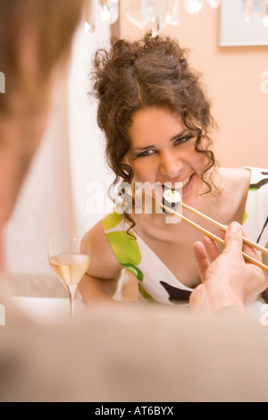 Man Feeding Woman Sushi Stock Photo