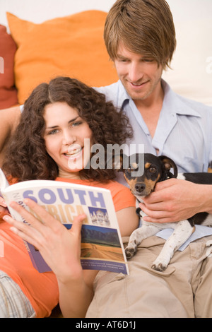 Young adults examining catalog Stock Photo - Alamy