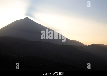 sunsetting over mount teide with shadow light falling on duststorm on mountain el teide tenerife canary islands spain Stock Photo