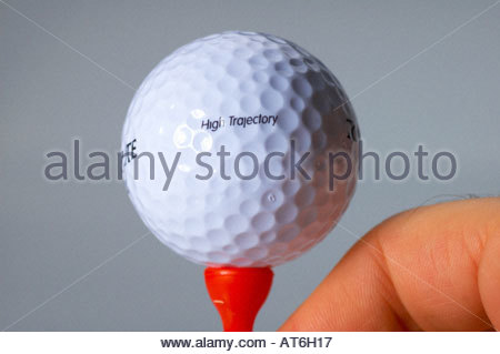 A closeup of a golfball on a red tee Stock Photo