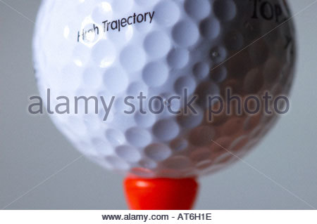 A closeup of a golfball on a red tee Stock Photo