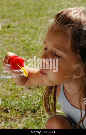 Girl (4-6) blowing bubbles, close-up Stock Photo