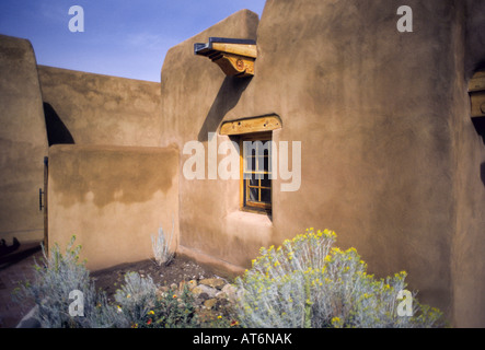 A view of an adobe wall which is part of a beautiful adobe mud brick home in Santa Fe New Mexico Stock Photo
