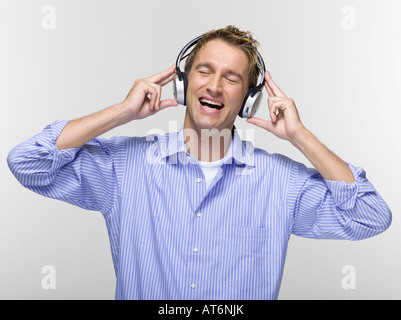Young man with eyes closed listening to music Stock Photo