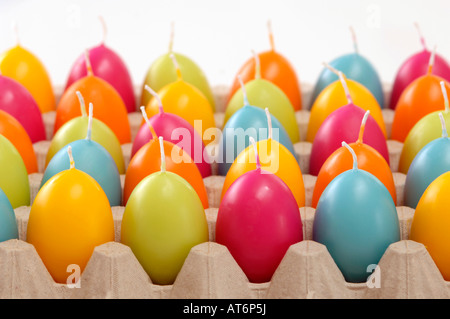Egg-shaped candles in cardboard box Stock Photo