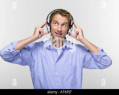 Young man wearing headphones listening to music, portrait Stock Photo