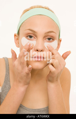 Woman applying adhesive plaster over nose, portrait Stock Photo