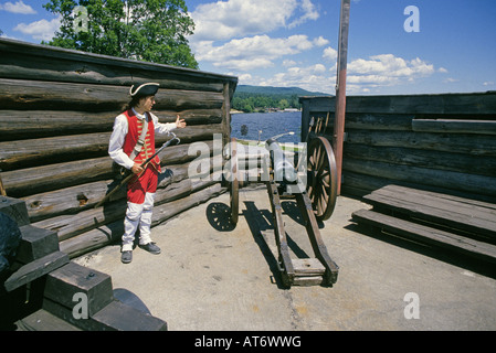 A reenactors dressed as a British soldier stands in front of a cannon at Fort Ticonderoga National Historic Landmark