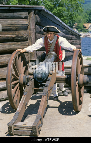 A reenactors dressed as a British soldier stands in front of a cannon at Fort Ticonderoga National Historic Landmark