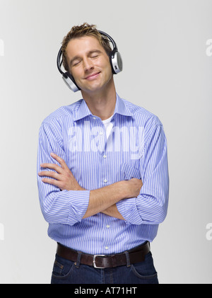Young man wearing headphones listening to music, portrait Stock Photo