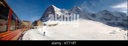 Jungfraujoch railway at Kleiner Scheidegg with the  North Face of the Eiger left, Monch Centre and Jungfrau right Stock Photo
