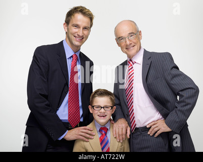 Grandson (8-9) grandfather and son wearing business cloth, portrait Stock Photo