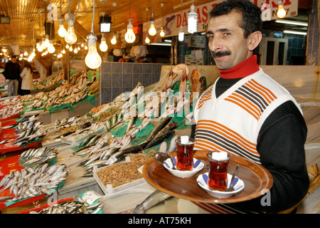 Traditional Turkish tea vendor in the Kumkapi fish market in Istanbul, Turkey. Stock Photo