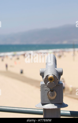 Telescope overlooking boardwalk and sunbathers enjoying a Southern California coastline. Stock Photo