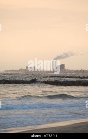 Smokestacks in the distance along the shoreline between Newport Beach and Huntington Beach highlight energy needs. Stock Photo