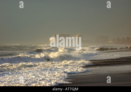 Beach hotel obscured by spray from rough sea, Malaga, Spain Stock Photo