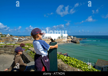 a young boy looking through a telescope at st.ives in cornwall,england Stock Photo