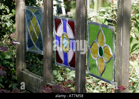 Decorative stained glass panels hanging inside a wooden frame Stock Photo