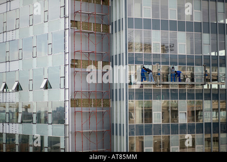 constructors installing new windows for an office building Stock Photo