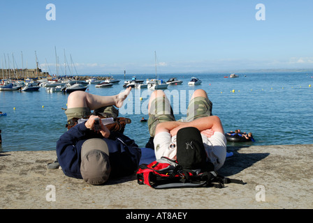 Couple relaxing on the quayside at Newquay, MId Wales Stock Photo