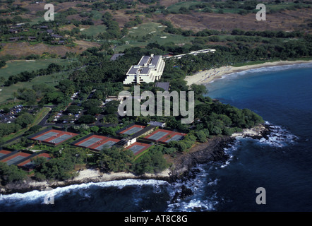 Aerial shot of the Mauna Kea Beach Hotel on the Big Island, with tennis courts, golf course and lush grounds next to white sand Stock Photo