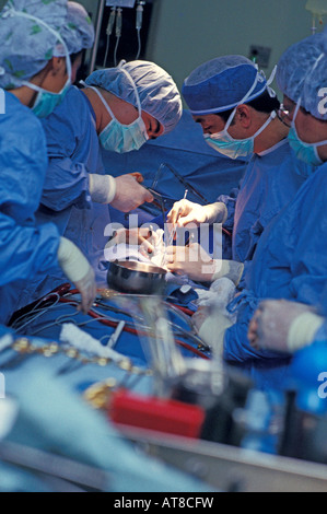 A team of surgeons and nurses perform an open heart surgery. Stock Photo