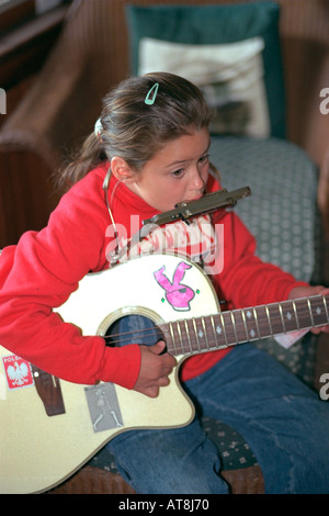 Talented girl age 6 performing one man band show. Cedarville Michigan USA Stock Photo
