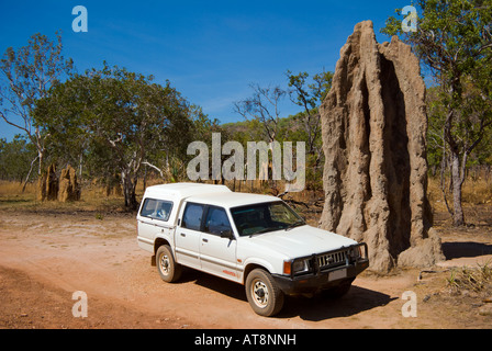 Our car beside giant termite mound beside Kakadu Highway north from Gunlom Kakadu NP Stock Photo
