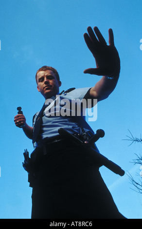 Police officer demonstrates C.S Cannister Stock Photo