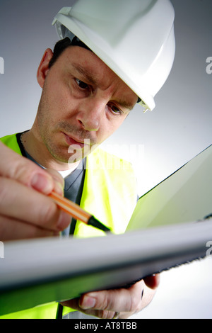Construction worker or surveyor writing into a notebook Stock Photo